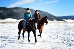 Sisters Jana Mills and Ashlee Rose Mills at home on horseback in Eagle Nest, New Mexico, January 2016