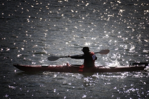 Kayak silhouette on Lake Maloya, Robert McIvor by Tim Keller