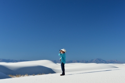 Peter Burg using binoculars at White Sands National Monument, by Tim Keller