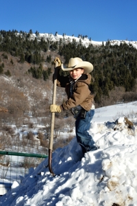 Chance Walton shoveling snow at Sugarite Canyon Ranch