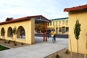 Bicyclist at sunrise, depot at Raton, New Mexico, by Tim Keller
