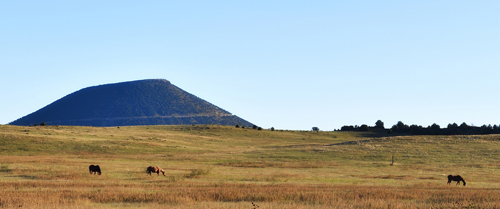 Capulin Volcano and horses grazing, by Tim Keller