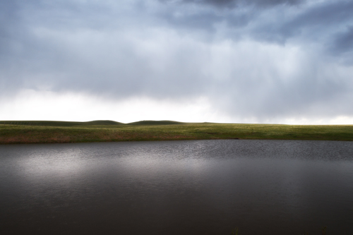 Johnson Mesa stock pond in thunderstorm