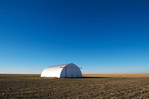 Storage garage in midst of miles of fallow Kansas fields, January